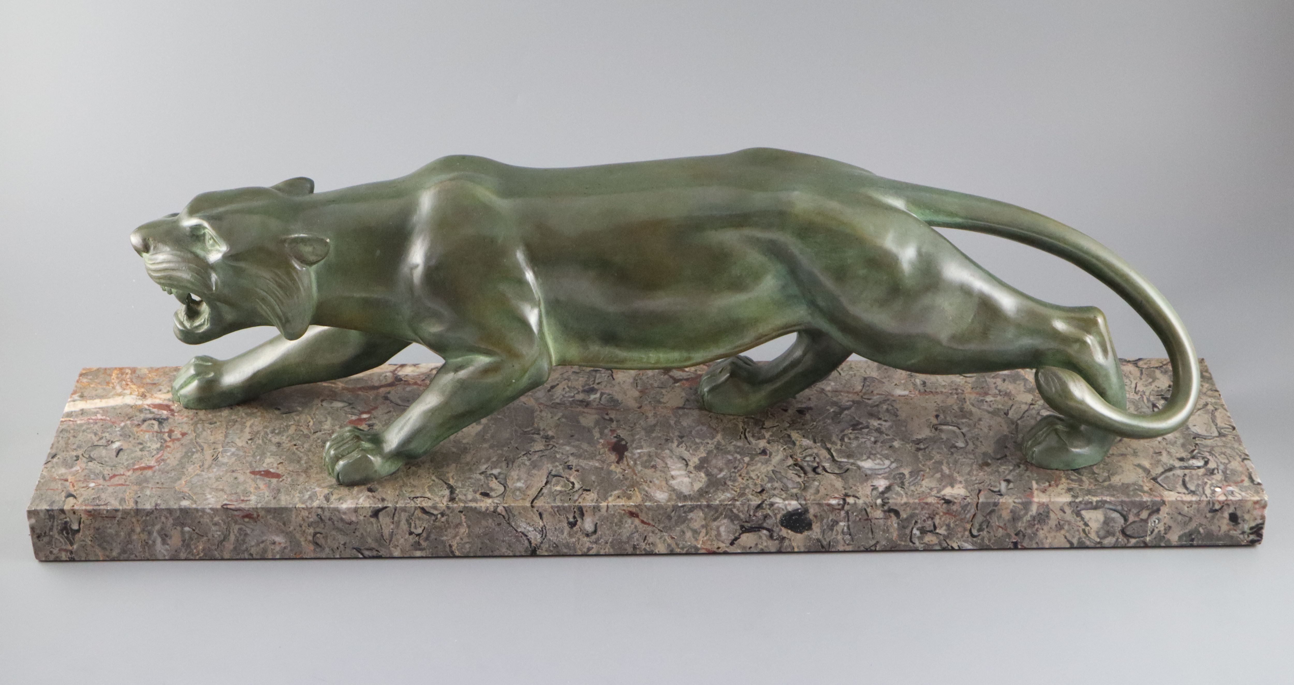 Brault. An Art Deco patinated bronze model of a prowling panther, width 29.5in. height 8.5in.